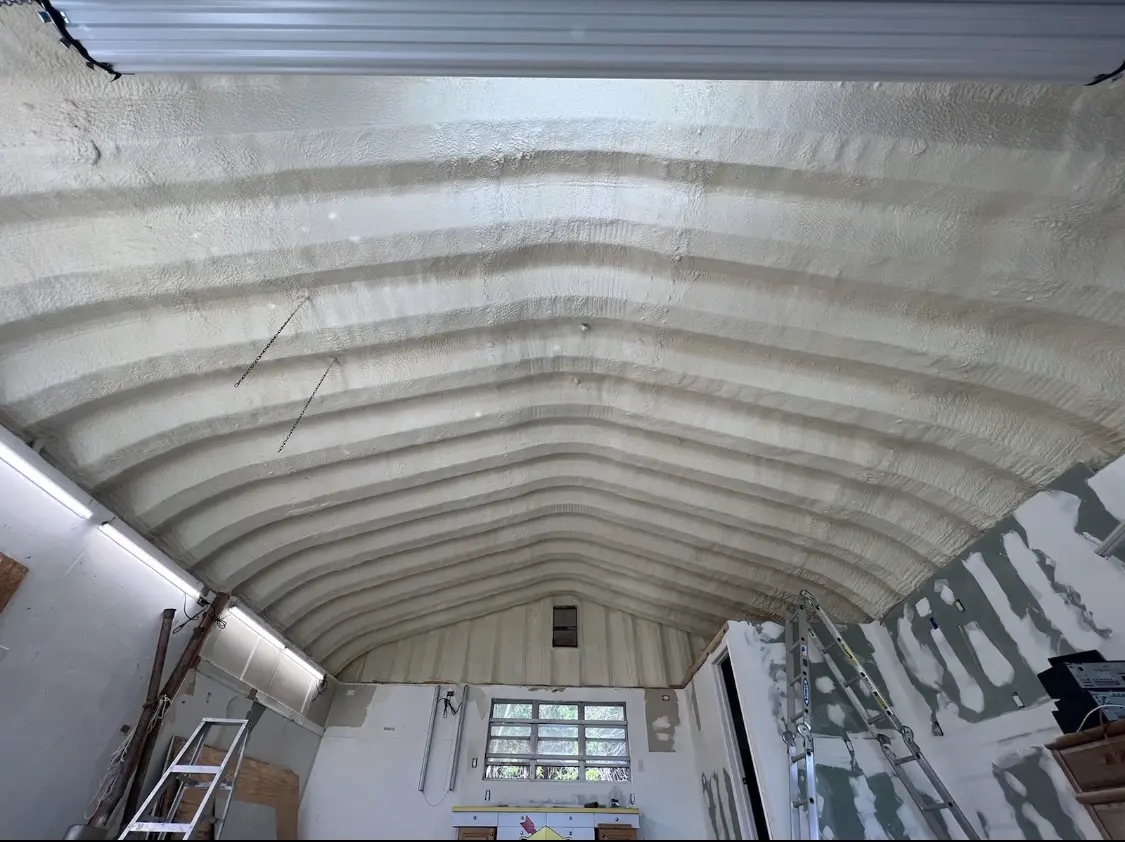 Spray polyurethane foam applied to the underside of a metal roof deck in Eudora